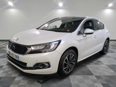 a white car is parked in a room with a checkered floor