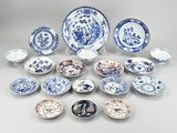 a lot of blue and white plates and bowls on the table