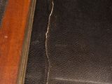 a picture of a piece of black leather on a wooden table