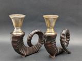 pair of antique brass candlesticks with horns and horns on them