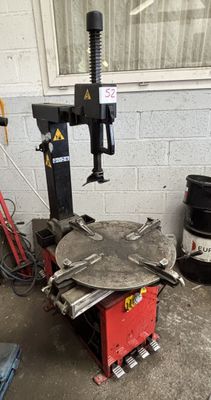 a machine that is sitting on the ground next to some barrels