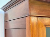 a wooden cabinet with a mirror on top of it