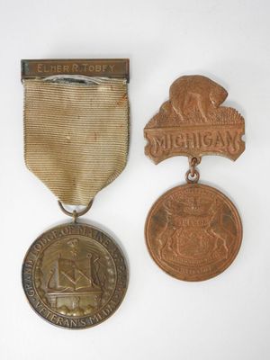 two medals and a medal on a white surface with a white background