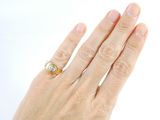 a woman ' s hand with a gold ring on it