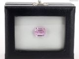 a pink tourmaline gems in a black box on a white surface
