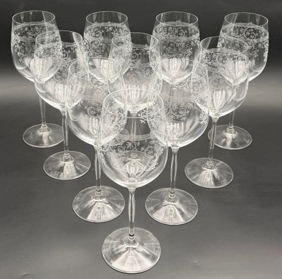 many wine glasses that are lined up on the table