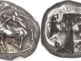 an ancient coin with a picture of a man on a horse