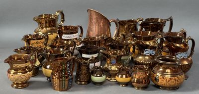 many different types of gold and silver vases on the table
