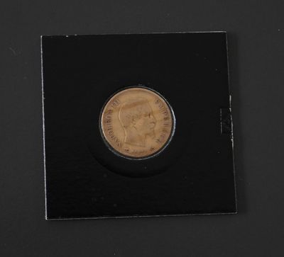 a coin with a picture of a man on it on a black surface