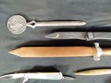 several different types of knives on a black table