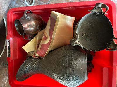 a red tray with a tea kettle, tea bag, and other items in it