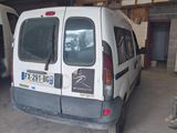 a white van parked in a garage with a man standing next to it