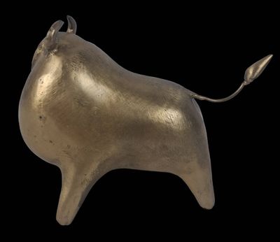 an image of a gold bull statue on a black background