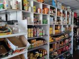 many shelves of food in a store that is empty