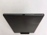 the back view of a tablet computer sitting on top of a white surface