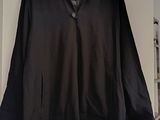 black jacket hanging on a white wall in a room