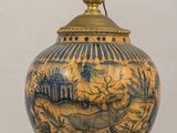an image of a blue and gold vase with a lamp on it