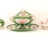 a green and white tea set on a white table