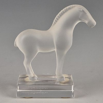a white horse that is standing on a clear base