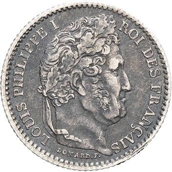 a silver coin with an image of a man ' s head on it