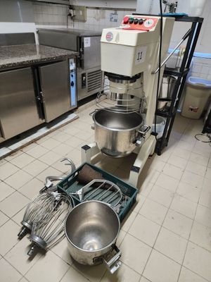 a kitchen with a mixer, mixer bowl, and other equipment in it
