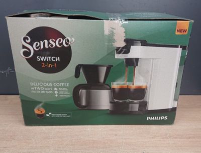 packaging of a coffee maker sitting on top of a wooden table
