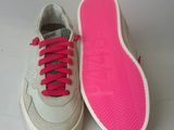 pair of white sneakers with pink laces on them on a white surface
