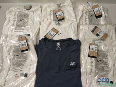 a lot of t - shirts and other items on the table