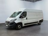 a picture of a white van parked in a large room