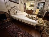 a bed that is in a room with a rug on the floor