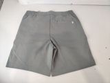 grey shorts on a white table with a white box in the background