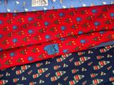several ties are stacked on top of each other on a table