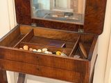 a small wooden table with a mirror on top of it