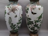 two vases sitting next to each other on a table