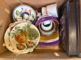 a cardboard box with a bunch of plates and cups in it