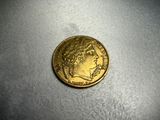 a gold coin sitting on top of a table