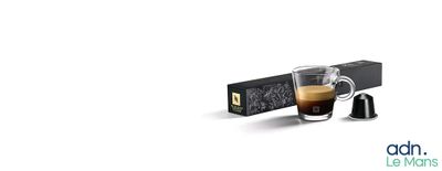 a glass of coffee next to a box of coffee beans