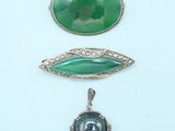 three pieces of jewelry including a broochle, a pendant and a broochele
