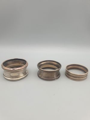 trois types différents de bagues en argent sur un fond blanc