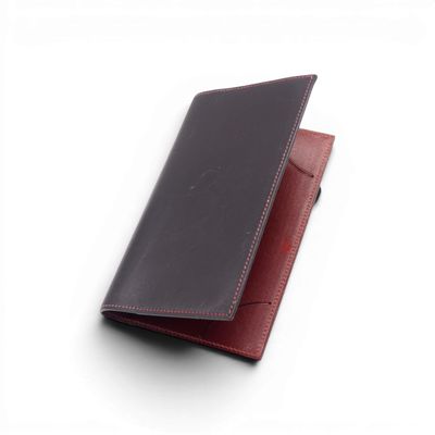 a black and red wallet sitting on top of a white surface