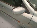a silver car with a mirror on the side of it
