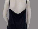 the back of a mannequin wearing a black top and black pants