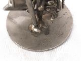 a statue of a man riding a motorcycle on a plate