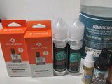a bottle of liquid, a bottle of liquid, a bottle of liquid, a bottle of liquid, and a box of liquid on a table