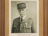an old photo of a man in a military uniform in a frame