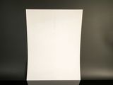 a white sheet of paper sitting on top of a black table