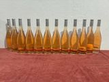 six bottles of wine are lined up on a table