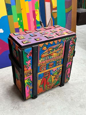 a colorful trunk sitting in front of a colorful wall