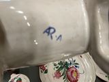 a person pouring something into a cup on a table