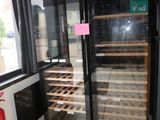 a wine cooler in the corner of a restaurant